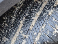 * 21-inch sport alloy wheels, dark-tinted radiator grille, unique front/rear bumpers, and large exha... (image 9)