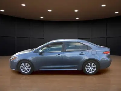 The 2021 Toyota Corolla LE in sleek gray with its reliable front-wheel drive and automatic transmiss...