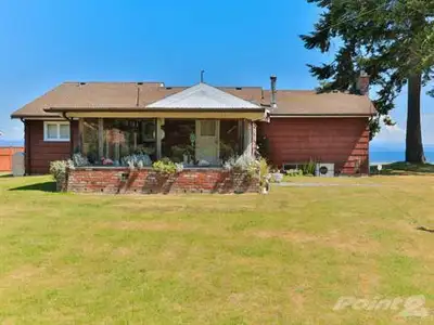 A lovely beachfront cottage originally crafted in 1955 and tastefully remodeled in more recent times...