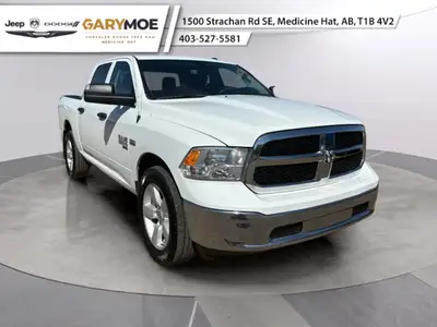 The 2023 Ram 1500 Classic SLT, dressed in a pristine White finish and featuring an efficient 4x4 dri...