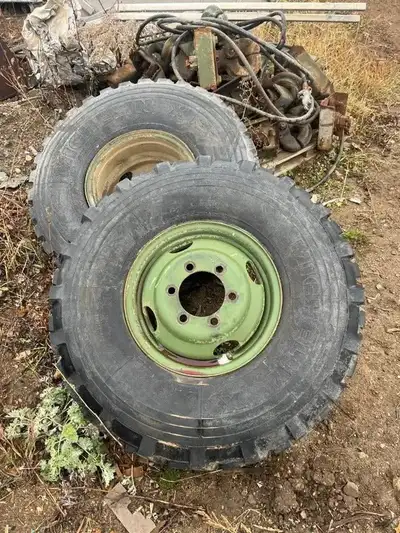 This 9.00R16 Michelin XZL tire and rim assembly is an authentic surplus unit removed from Canadian M...