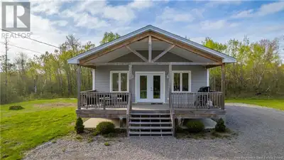 Discover the charm of single-level living in this chalet-style beach house, nestled on +/- two acres...