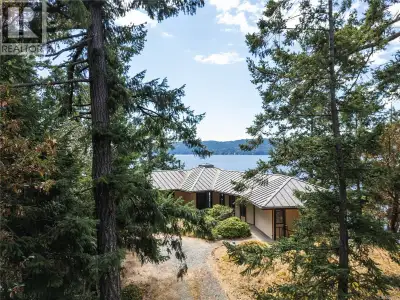 Architect-designed, custom-built oceanfront home bathed in sunlight and nestled at the coveted end o...