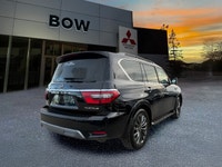 The 2023 Nissan Armada 4x4 Platinum in a striking black finish is a powerhouse SUV designed for both... (image 3)