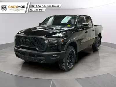 The 2026 Ram 1500 Rebel 4x4 Crew Cab in a striking black hue offers a commanding presence on any ter...