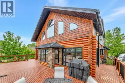 Experience the best of four-season lake living in this impressive custom log home located in the sou...