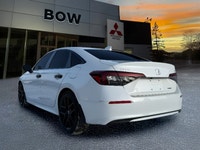 The 2025 Honda Civic Sedan Hybrid Sport in a stunning white finish combined with its FWD drivetrain... (image 6)