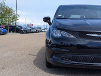 The 2026 Chrysler Grand Caravan SXT in Diamond Black Crystal Pearl with a Black interior offers a bl... (image 9)