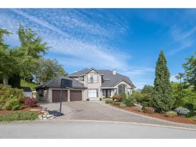Fraser Heights Executive Home with panoramic mountain views, a fully landscaped West Coast garden, a...