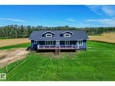 Enjoy peaceful acreage living just minutes from Smoky Lake on this stunning 12.38-acre property feat...