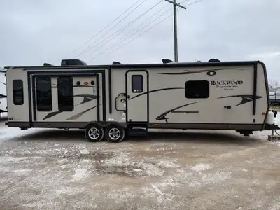 The 2013 Rockwood 8329SS is a three-slide-out travel trailer from the Signature Ultra Lite series, f...