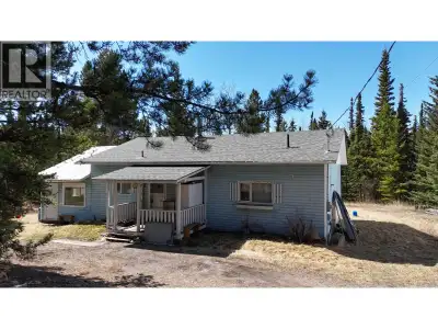 Nestled on five private, treed acres just steps from beautiful Cluculz Lake, this well-maintained th...
