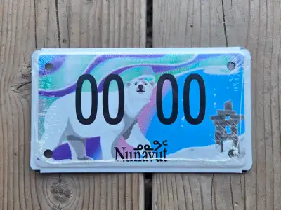 Modern style Nunavut motorcycle sample license plate. Aluminum with multi coloured graphics. Dimensi...