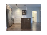 Each suite includes a stainless-steel fridge, stove, dishwasher, and microwave by Whirlpool, as well... (image 4)