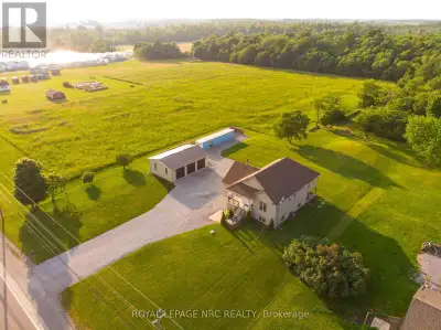 You will love this custom-built raised bungalow on a private 1-acre lot, complete with a massive 36'...
