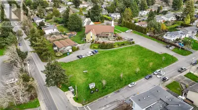 Located at 1806 San Juan Avenue in Saanich, BC, this 2.02-acre corner property is a prime redevelopm...