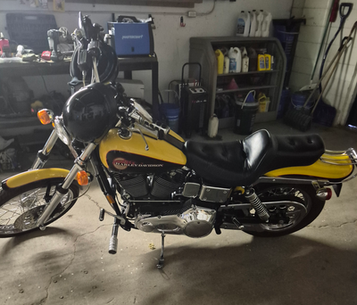This Harley-Davidson Dyna Super Glide is a powerful and iconic cruiser, featuring a striking yellow...