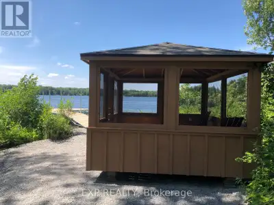 Discover the Untouched Beauty of Sharbot Lake. Set on an expansive 4.9-acre lot with 150 feet of sho...