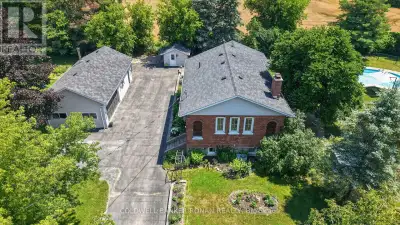 Nestled on a beautifully landscaped and fully fenced 1.07-acre property, this one-of-a-kind converte...