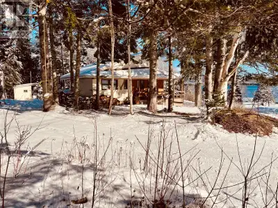 Perched overlooking the sparkling waters of Halls Bay, this enchanting ocean-view cabin offers a rar...