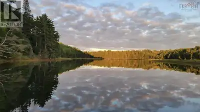 Discover the opportunity to build your dream home or year-round retreat on Lot 6 right on the river!...