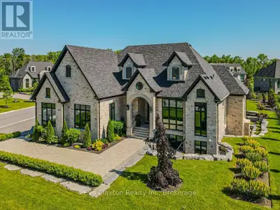 Custom built all natural stone bungalow on a half acre in the prestigious gated community of Heritag...