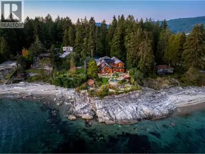 Perched majestically on a magnificent .96 acre waterfront estate, this West Coast timbered masterpie...