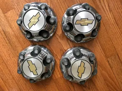 THESE ARE 4 BRAND NEW NEVER USED ORIGINAL OEM FACTORY GM PARTS THAT WILL FIT 16" 17"CHROME WHEELS ON...