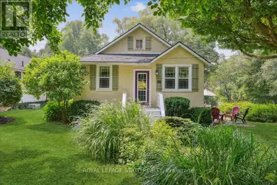 Charming 2-bedroom Craftsman bungalow on a desirable corner lot just three blocks from Queen Street...