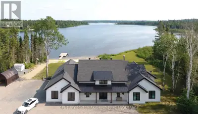Luxurious 2,700+ sq ft executive home with over 250 feet of pristine frontage on beautiful Pike Lake...
