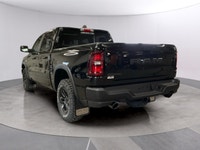 The 2026 Ram 1500 Rebel in Black, featuring a robust 4x4 drivetrain and precision handling, is ready... (image 2)