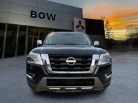 The 2023 Nissan Armada 4x4 Platinum in a striking black finish is a powerhouse SUV designed for both... (image 1)