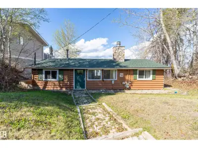 Nestled along the sought-after shores of Pigeon Lake, this charming waterfront bungalow with newer w...
