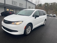 Experience the 2024 Chrysler Grand Caravan SXT in a pristine white finish, complete with efficient f... (image 1)