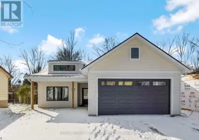 This new, NO-STEP bungalow with a covered front porch sits on a spacious 165ft lot, surrounded by ma...