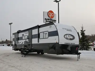 The 2026 Grey Wolf 26KF is a mid-size travel trailer with a front kitchen layout and a slide-out tha...