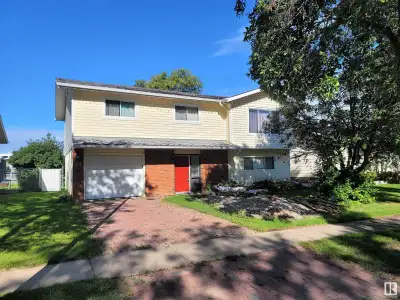 Charming two storey home with a singe attached garage, large fenced off yard, shed and a fish pond....
