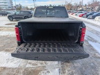The 2026 Ram 1500 RHO Crew Cab in Diamond Black Crystal Pearl delivers bold styling and high-perform... (image 5)