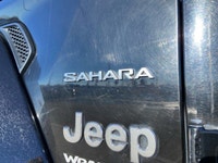 This Jeep Wrangler has a strong Gas/Electric V-6 3.6 L/220 engine powering this Automatic transmissi... (image 9)