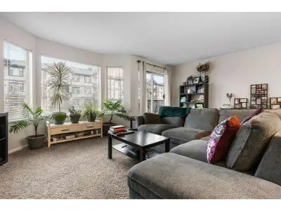 Bright, beautifully maintained condo offering an abundance of natural light through oversized window...