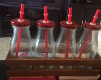 4-milk bottles with straws glass in wooden crate