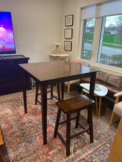 Wood Bar-height table with 4 saddle stools, View more