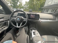 Experience the luxury of driving a black 2023 BMW X1 xDrive28i Sports Activity Vehicle with its comp... (image 6)