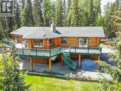 Welcome to this impressive executive log home, perfectly situated on a beautiful 1-acre lot with swe...