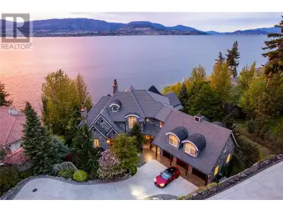 Lakefront vineyard estate home on 2.31 private acres w/160’ of sandy beach. State of the art geother...