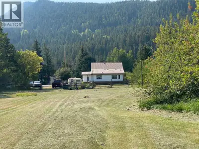 Beautiful acreage right on the Crowsnest River! You will love the tranquility of this park like sett...