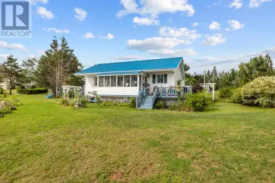 Discover the serene beauty of coastal living with this delightful three season summer home nestled o...