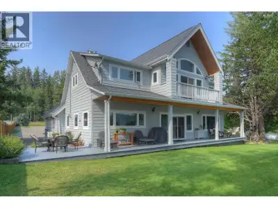 Custom-built lakefront home with a rare LEVEL DRIVEWAY, beautifully landscaped yard and gorgeous sha...