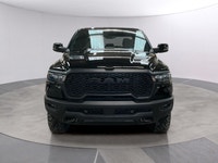 The 2026 Ram 1500 Rebel 4x4 Crew Cab in a striking black hue offers a commanding presence on any ter... (image 7)