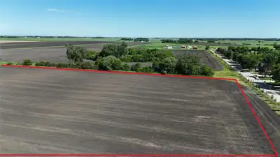 P05//Portage La Prairie/Uncover a rare, high-yield investment with this expansive 7-acre parcel (one...